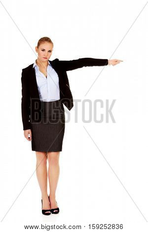 Angry business woman shows get out gesture