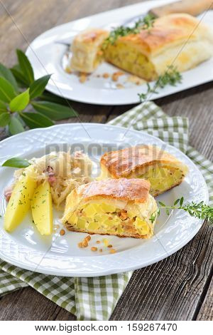 Hearty Austrian cuisine: Potato strudel with greaves, served with bacon sauerkraut