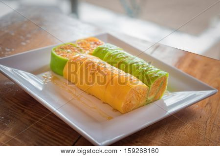 rolled cake (Foi Thong cake) on wooden