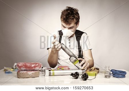 Man making classic type of tube bomb at home