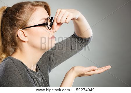 Girl Pinches Her Nose Because Of Stench Stink.