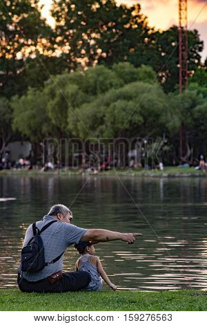 Grandpa And Nephew Relaxing In Chatuchak Park