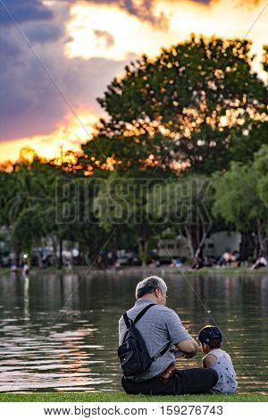 Grandpa And Nephew Relaxing In Chatuchak Park