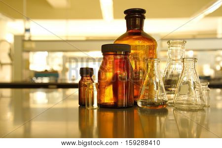 glass flask and retro brown bottle reagent in research lab science