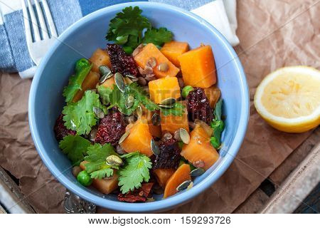 Vegan garnish. Boiled sweet potatoes with green peas cilantro and linseed oil. Perfect for the detox diet or just a healthy meal. Love for a healthy raw food concept.