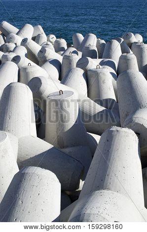 New gray concrete tetrapods in sunny day