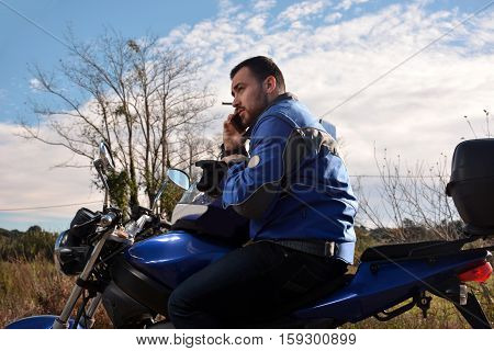 Biker Talking By Phone With His Smarth Phone