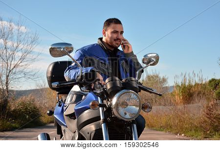 Biker Talking By Phone With His Smarth Phone