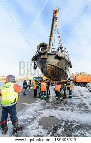 MOSCOW, RUSSIA - NOVEMBER 11, 2016: State Unitary Enterprise Mosvodostok performs recovery vessels on coastal winter parking. Installation work on the shores of the vessel.