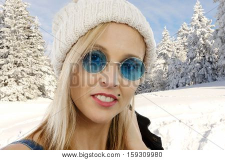 Portrait of a beautiful blond middle-aged woman with sun glasses