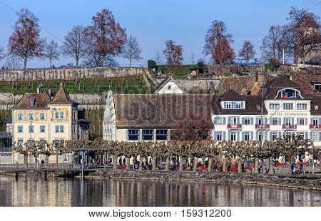 Rapperswil, Switzerland - 30 November, 2016: buildings in the historic part of the town, people on the embankment of Lake Zurich. Rapperswil is a part of the municipality of Rapperswil-Jona in the Swiss Canton of St. Gallen.