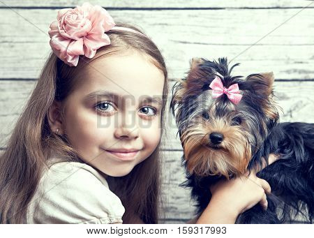 Girl with puppy of breed Yorkshire Terrier