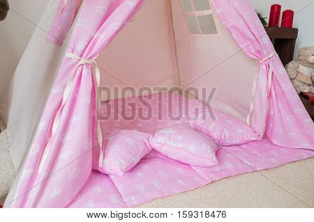 pilows in teepee in child playroom at home