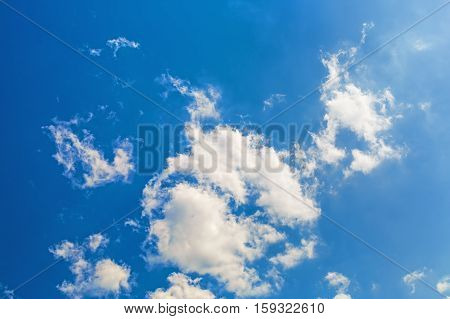 Blue sky with white fluffy cumuli clouds.