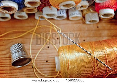 Sewing kit on the old wooden desk