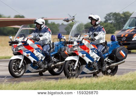 VOLKEL NETHERLANDS - JUN 15 2013: Dutch military police (Marechaussee) officers patrolling on their bike at the Royal Netherlands Air Force Open Day.