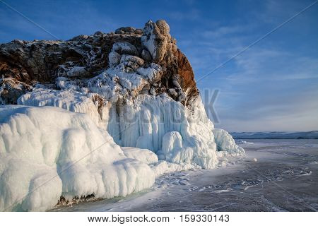 Winter landscape with rock covered with ice