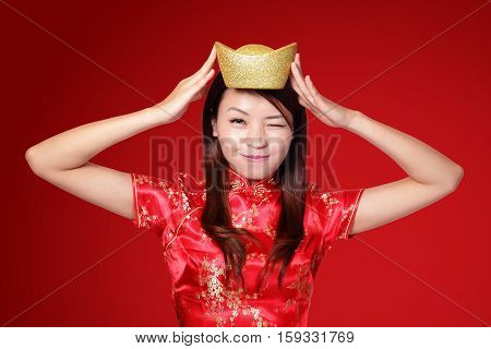 happy chinese new year. smiling asian woman showing gold for lucky. chinese mean get rich and happy
