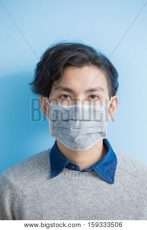 man feel sick with isolated blue background asian