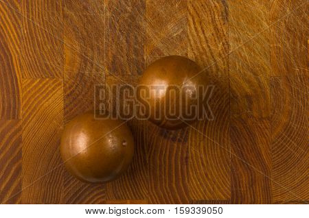 pair of copper Chinese singing balls Baoding of health for hands on wooden background
