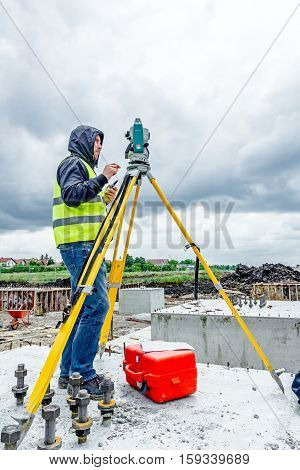 Zrenjanin Vojvodina Serbia - May 28 2015: Surveyor engineer is measuring level on construction site. Surveyors ensure precise measurements before undertaking large construction projects.