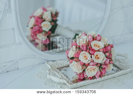 Wedding rose bouquet on a antique mirror