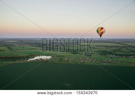 Balloon on a background of the beautiful green landscape