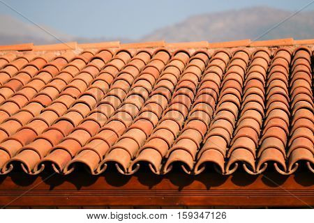 Red clay roof tiles. Built. Detail .
