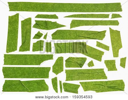 Collection of green used masking tape pieces