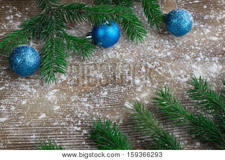 Christmas Tree Branches, Blue Balls On Winter Snowed Wooden Background