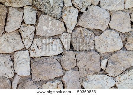 Wall made of stones of different shapes and sizes. Background