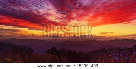 Amazing mountain landscape with colorful vivid sunset on the bright sky, natural outdoor travel background