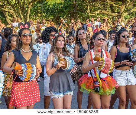 27 November, 2016. Beautiful women in short skirts and shorts playing percussions and dancing in the street at Festival de Fanfarras Ativistas - HONK RiO 2016 at Leme, Rio de Janeiro, Brazil