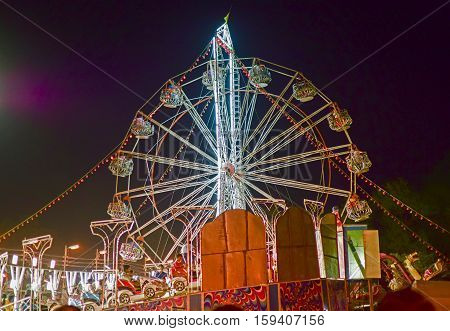 HOWRAH WEST BENGAL INDIA - MARCH 1ST MARCH 2015 : Roller coster ride at Howrah West Bengal India. Shot at night with colored lights.