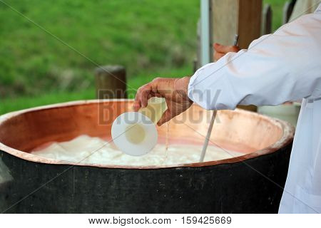 Cheesemaker Pour Rennet Into The Great Copper Cauldron