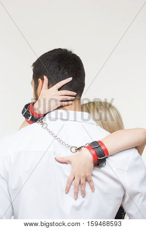 handcuffed sexy couple in handcuffs. Isolated on white background