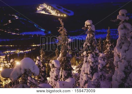 Beautiful cold mountain view of ski resort, winter day with slope, piste and ski lift, evening twilight night picture