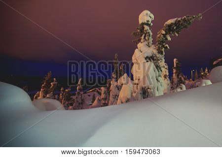 Beautiful cold mountain view of ski resort, winter day with slope, piste and ski lift, evening twilight night picture