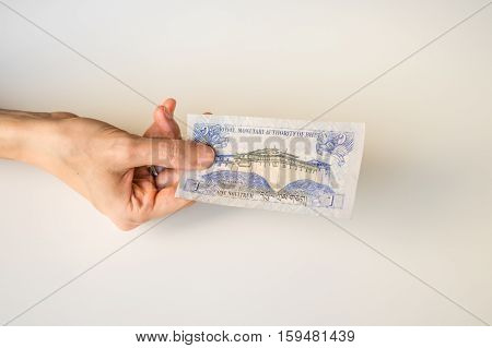 Woman Holding One Bhutanese Ngultrum Banknote In Her Hand