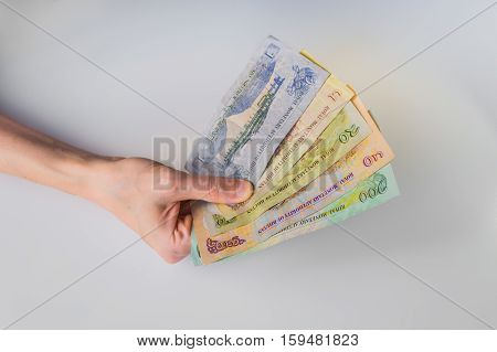 Woman Holding A Bunch Of Bhutanese Ngultrum Banknotes In Her Hand