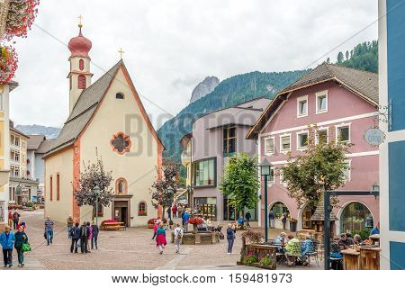 ORTISEI,ITALY - SEPTEMBER 16,2016 - Place with Church of Saint Antonius in Ortisei. Ortisei is a town in South Tyrol in northern Italy. It occupies the Val Gardena within the Dolomites a mountain chain that is part of the Alps.