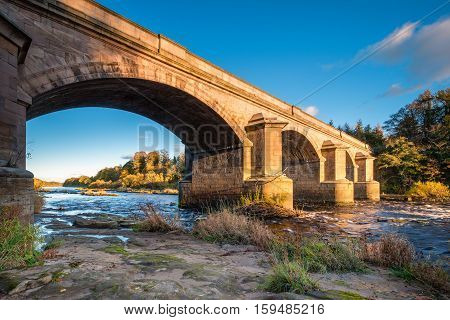 River Tyne flows under Bywell Bridge, through Northumberland, under the stone arched Bywell Road Bridge near Stocksfield