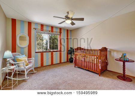 Bright Colorful Nursery Room With Contrast Striped Wall