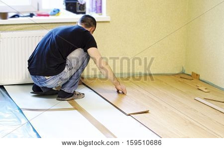 The Process Of Installing Laminate Wooden On The Floor