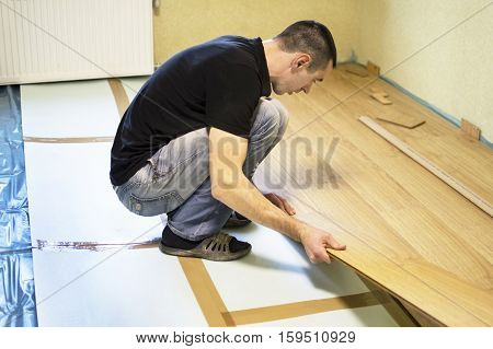 The Process Of Installing Laminate Wooden On The Floor