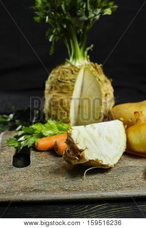 Ingredients for celeriac soup - celery root - celeriac carrots onion potatoes - healthy diet concept