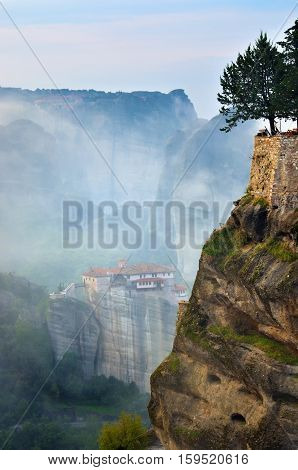 Meteora monasteries. Beautiful view on the rocks and the Holy Monastery Roussanov placed on the edge of high rock before sunrise Kastraki Greece