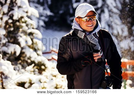 Man Drinks Tea In Cold Winter Forest With Snow