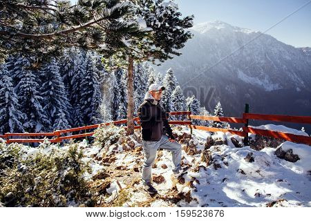 Man Drinks Tea In Cold Winter Forest With Snow