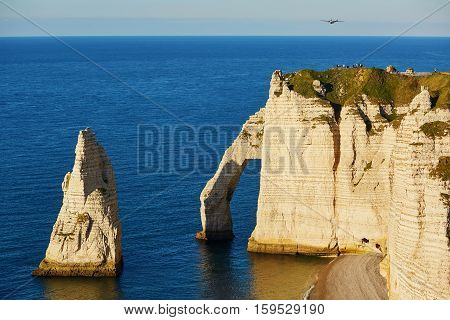 Scenic View Of Etretat Cliffs With Plane
